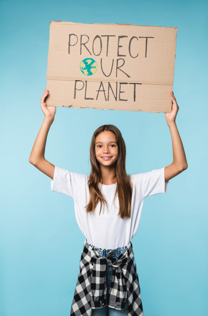 Eco-activist with carton poster with save planet logo for environment conservation, anti-pollution